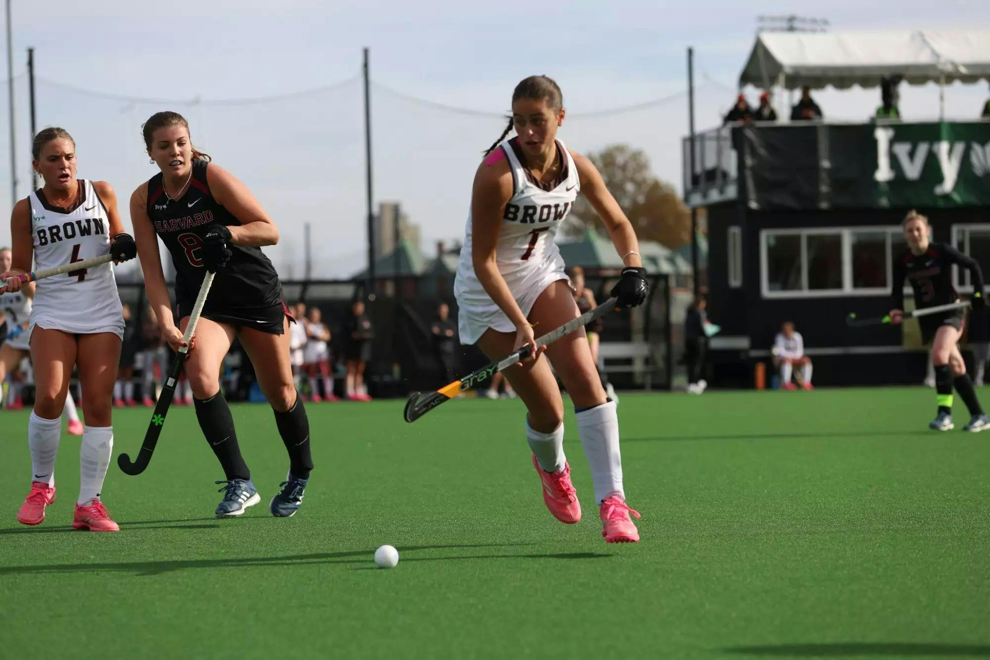 Photo of a Field Hockey player rushing towards the ball. 