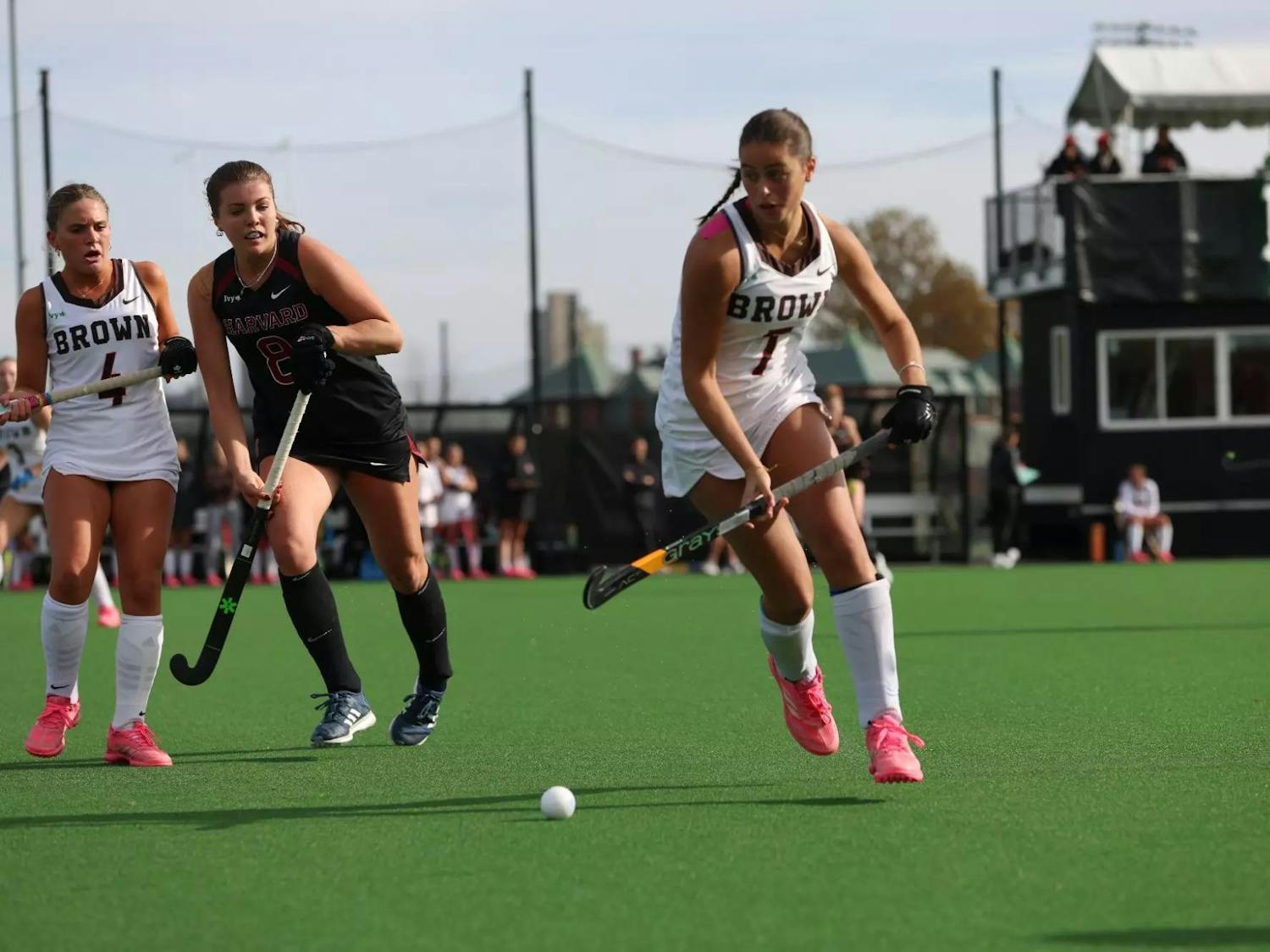 Photo of a Field Hockey player rushing towards the ball.