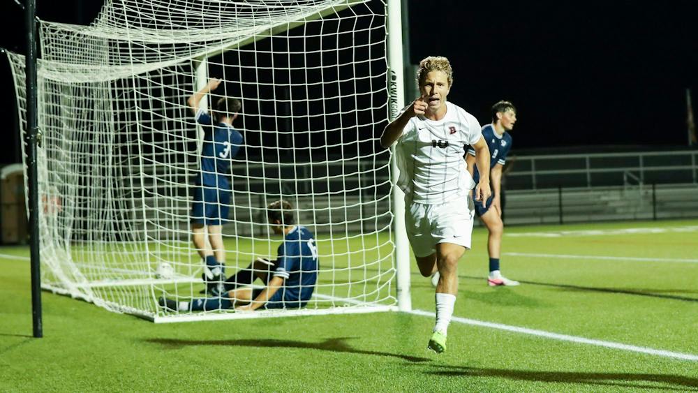 Photo of a Brown Men's Soccer player celebrating after scoring a goal. Courtesy of Brown Athletics