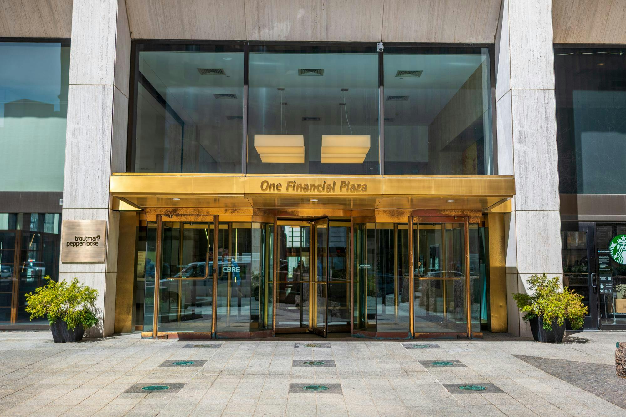 A picture of One Financial Plaza building which has a gold entrance.