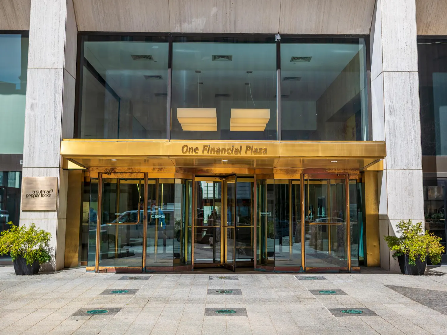 A picture of One Financial Plaza building which has a gold entrance.