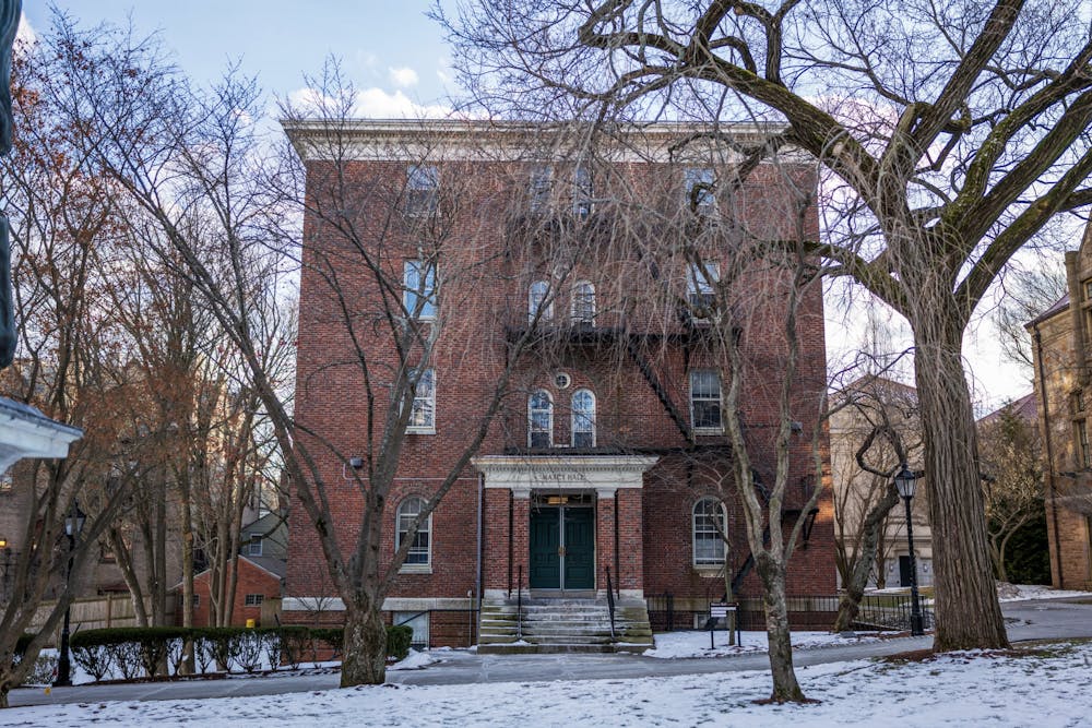 A photograph of Maxcy Hall, with bare trees in front and snow on the ground.