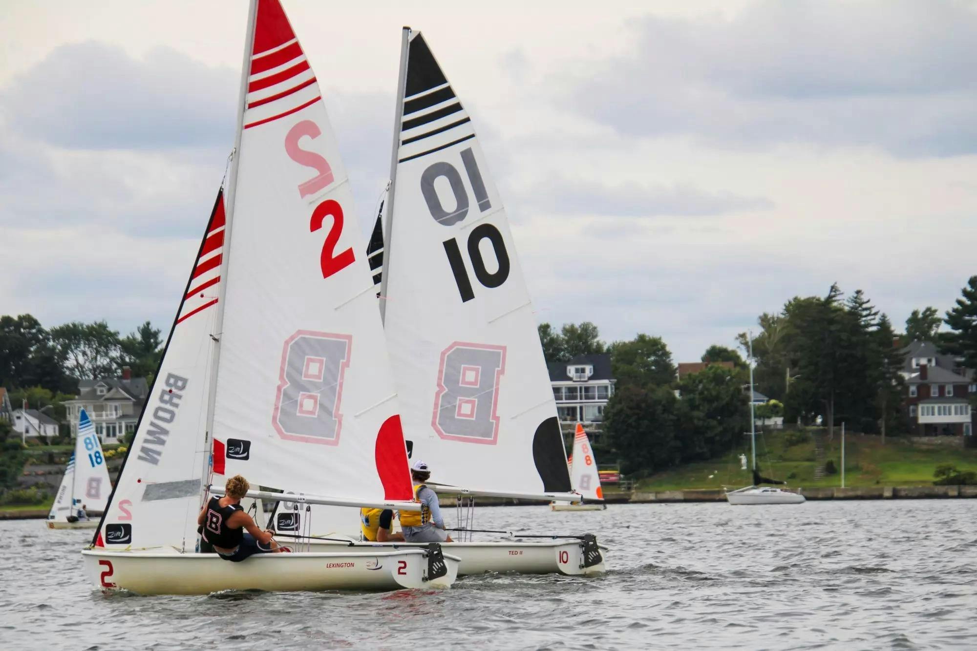 Photo of two Brown University sailors on a body of water.