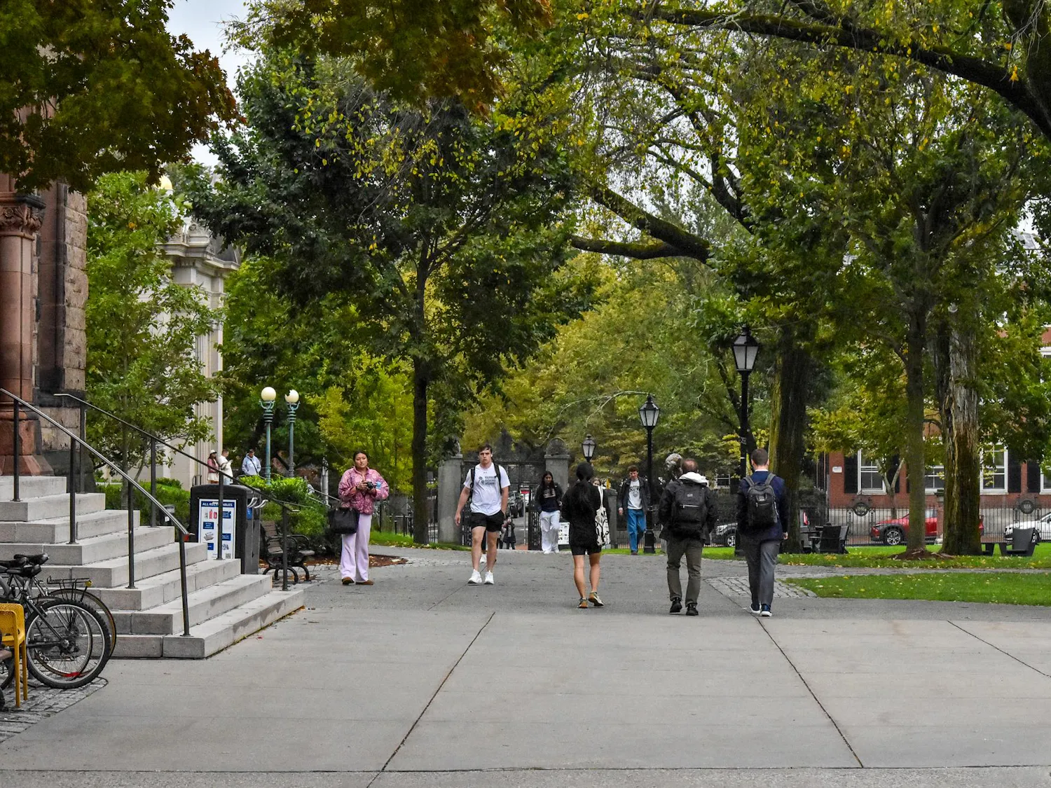 Photo of the Main Green during a high-traffic period, with many students walking and talking along the main walking path of the green.