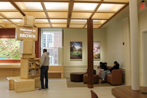 Photo of interior of the new admissions center, with a tall pillar that says "Welcome to Brown"