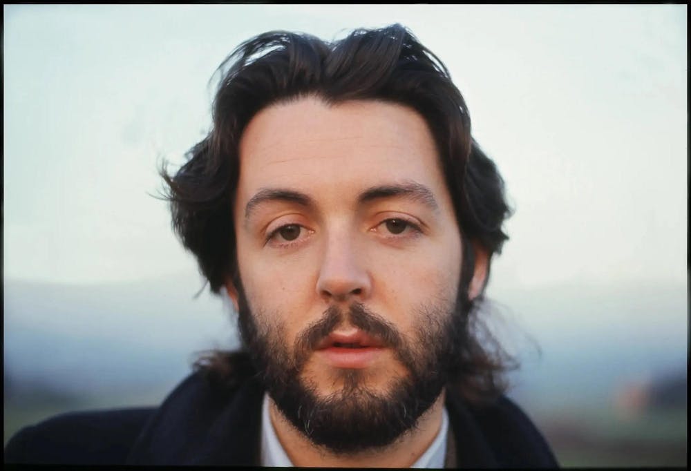 Shot from “Man on the Run” (2025) featuring a close-up portrait of Paul McCartney with a blurred background.