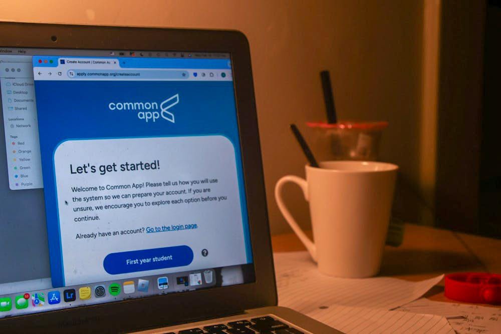 A photo of an open laptop displaying the login page to the Common App website.