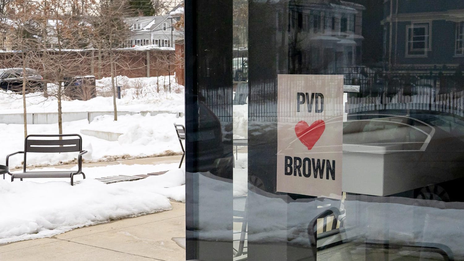 A photo of a “PVD loves Brown” flyer posted on the window of a building.