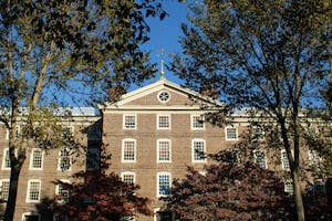 A photo of University Hall with multi-colored fall trees surrounding it.