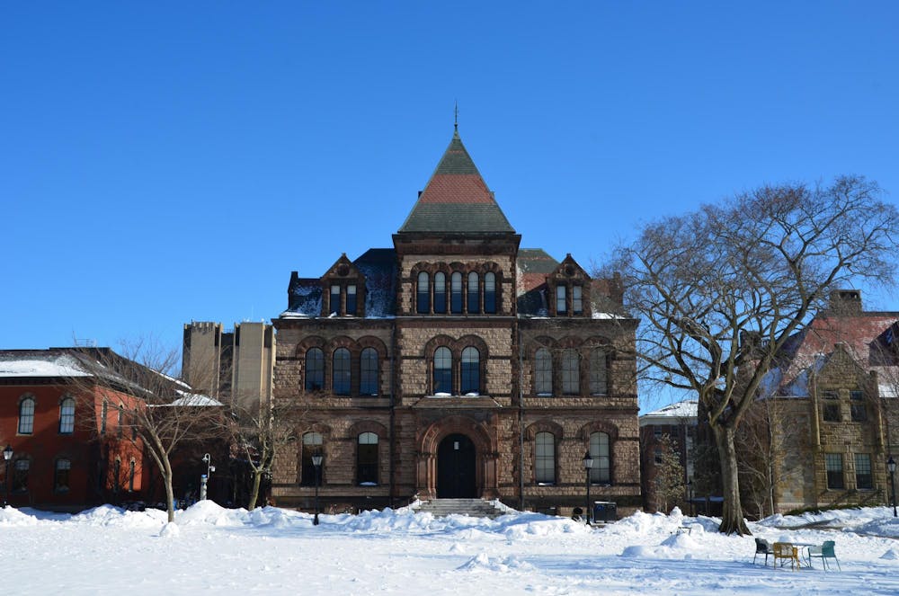 A photo of Sayles Hall on the Main Green covered in snow.