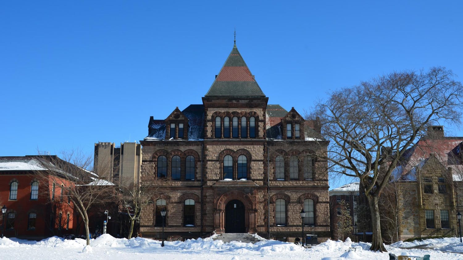 A photo of Sayles Hall on the Main Green covered in snow.