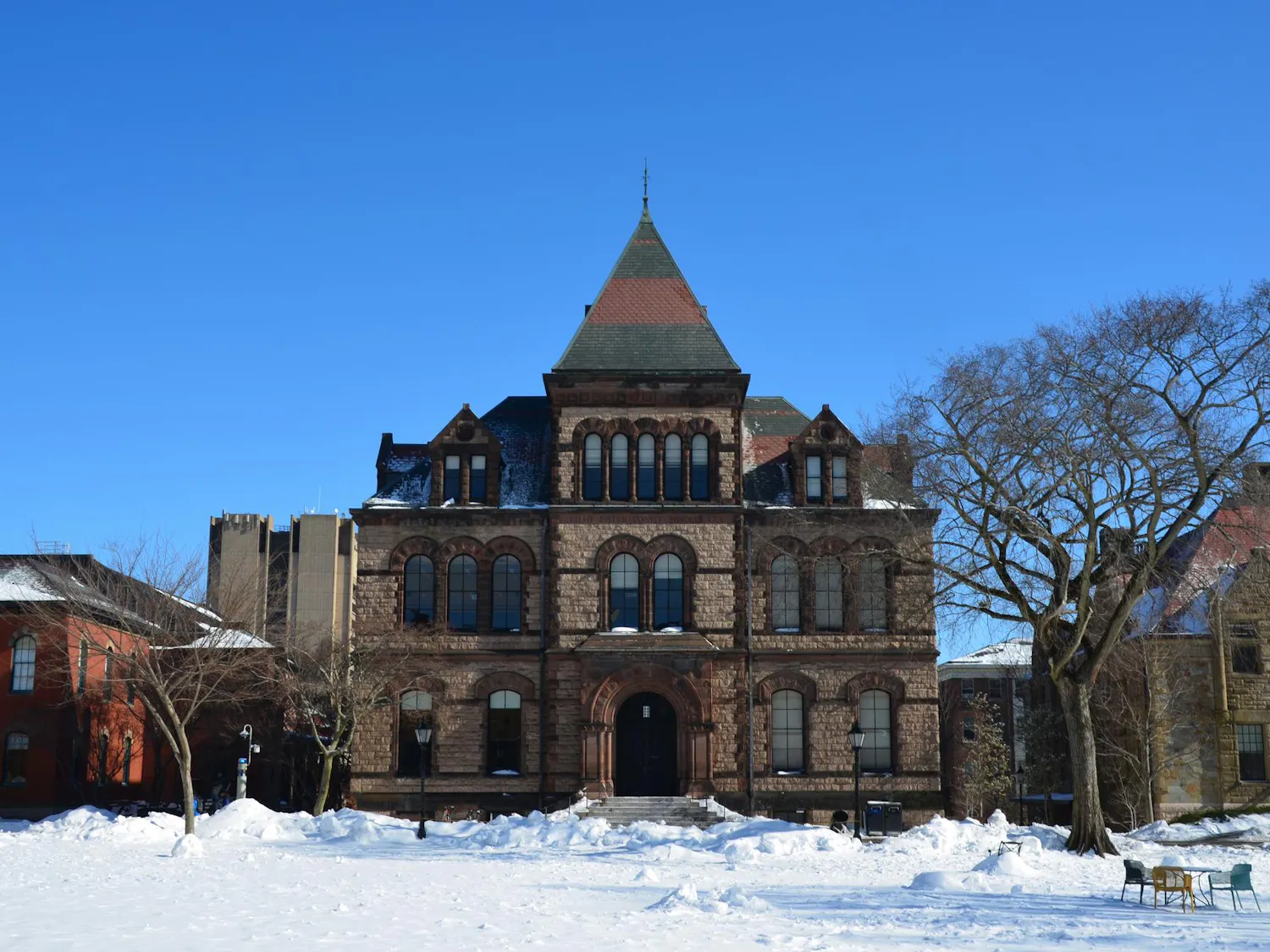 A photo of Sayles Hall on the Main Green covered in snow.