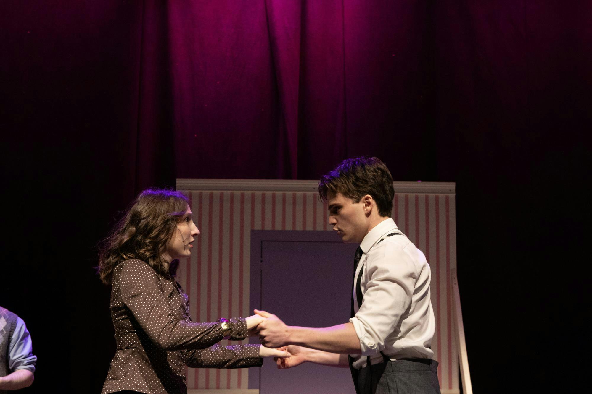 A photo of Charlie Fitzgerald ’28, playing Georg Nowack, and Isabel Levine ’28, playing Amalia Balash, looking at each other and holding hands.