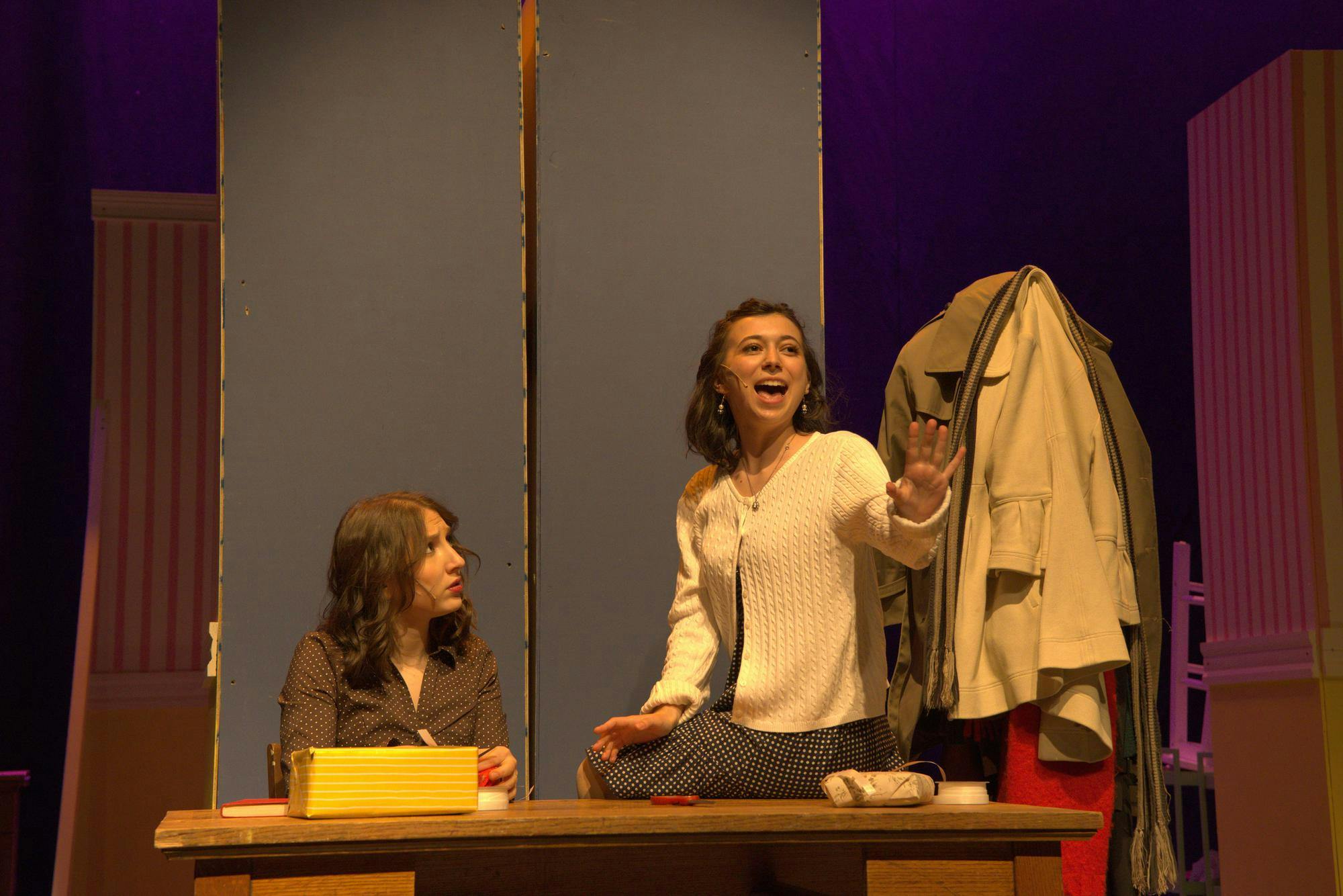 A photo of Isabel Levine ’28, playing Amalia Balash, singing to Zoe Dinnerstein ’28, playing Ilona Ritter.