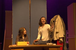 A photo of Isabel Levine ’28, playing Amalia Balash, singing to Zoe Dinnerstein ’28, playing Ilona Ritter.
