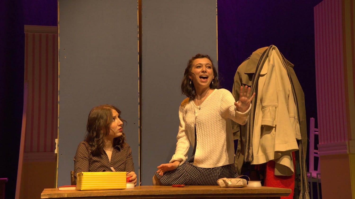 A photo of Isabel Levine ’28, playing Amalia Balash, singing to Zoe Dinnerstein ’28, playing Ilona Ritter.
