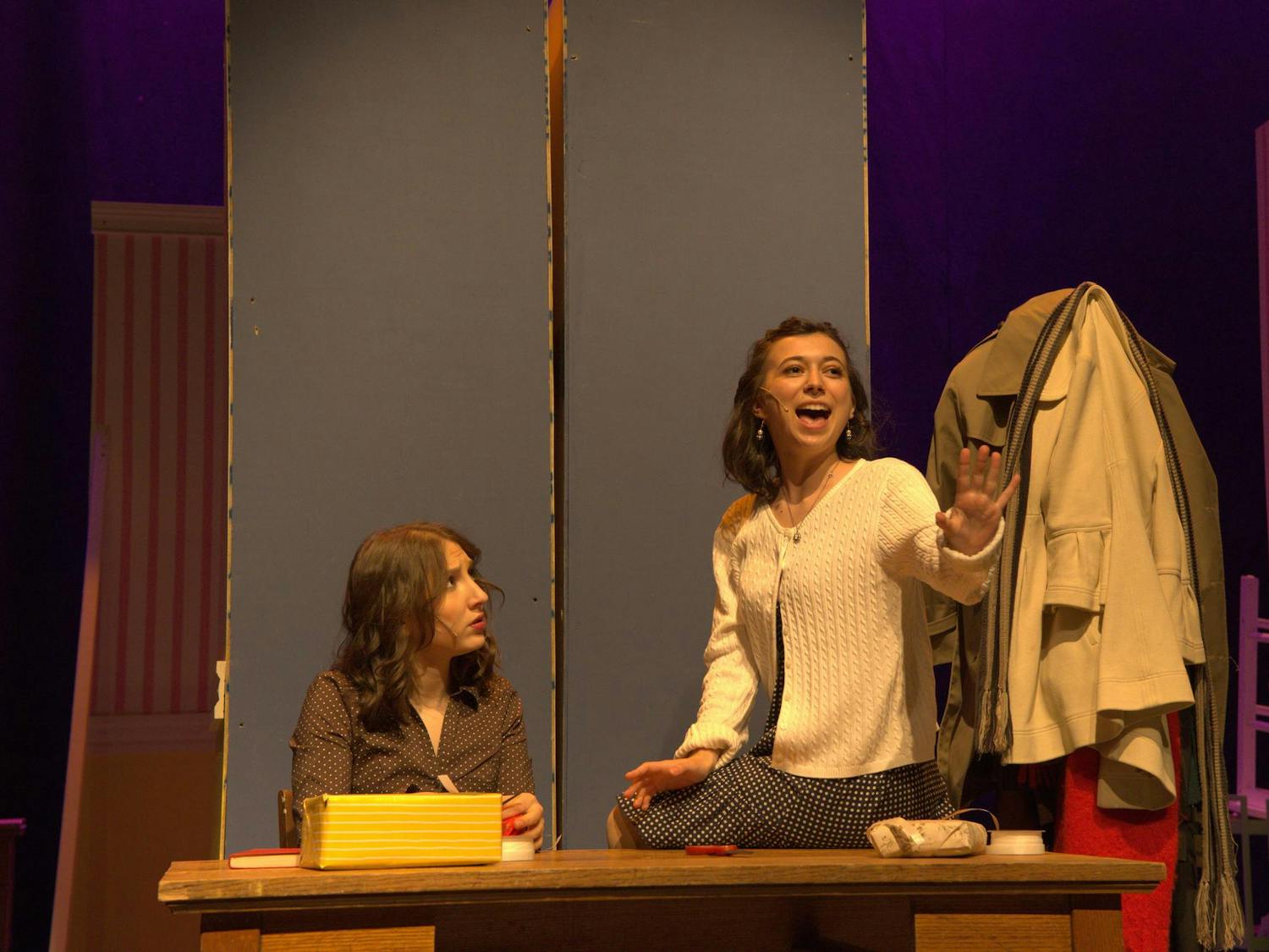 A photo of Isabel Levine ’28, playing Amalia Balash, singing to Zoe Dinnerstein ’28, playing Ilona Ritter.