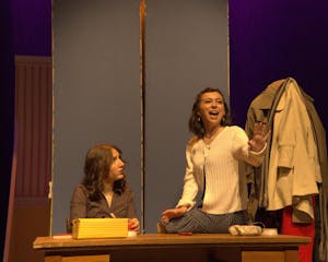 A photo of Isabel Levine ’28, playing Amalia Balash, singing to Zoe Dinnerstein ’28, playing Ilona Ritter.