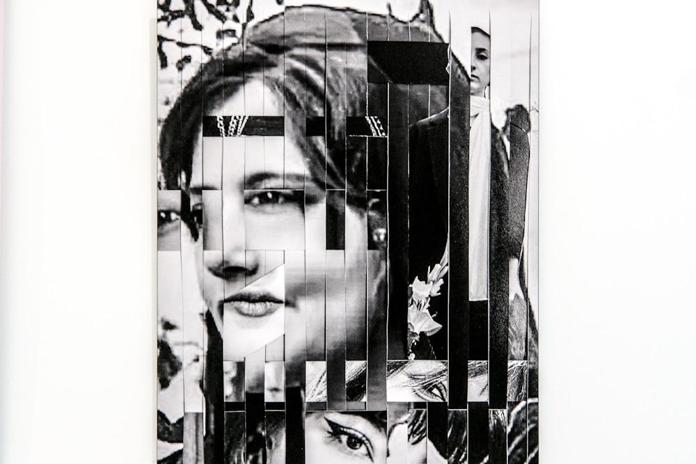 A photographic work with sliced pieces from multiple different photographs of women's faces, on a white gallery wall.