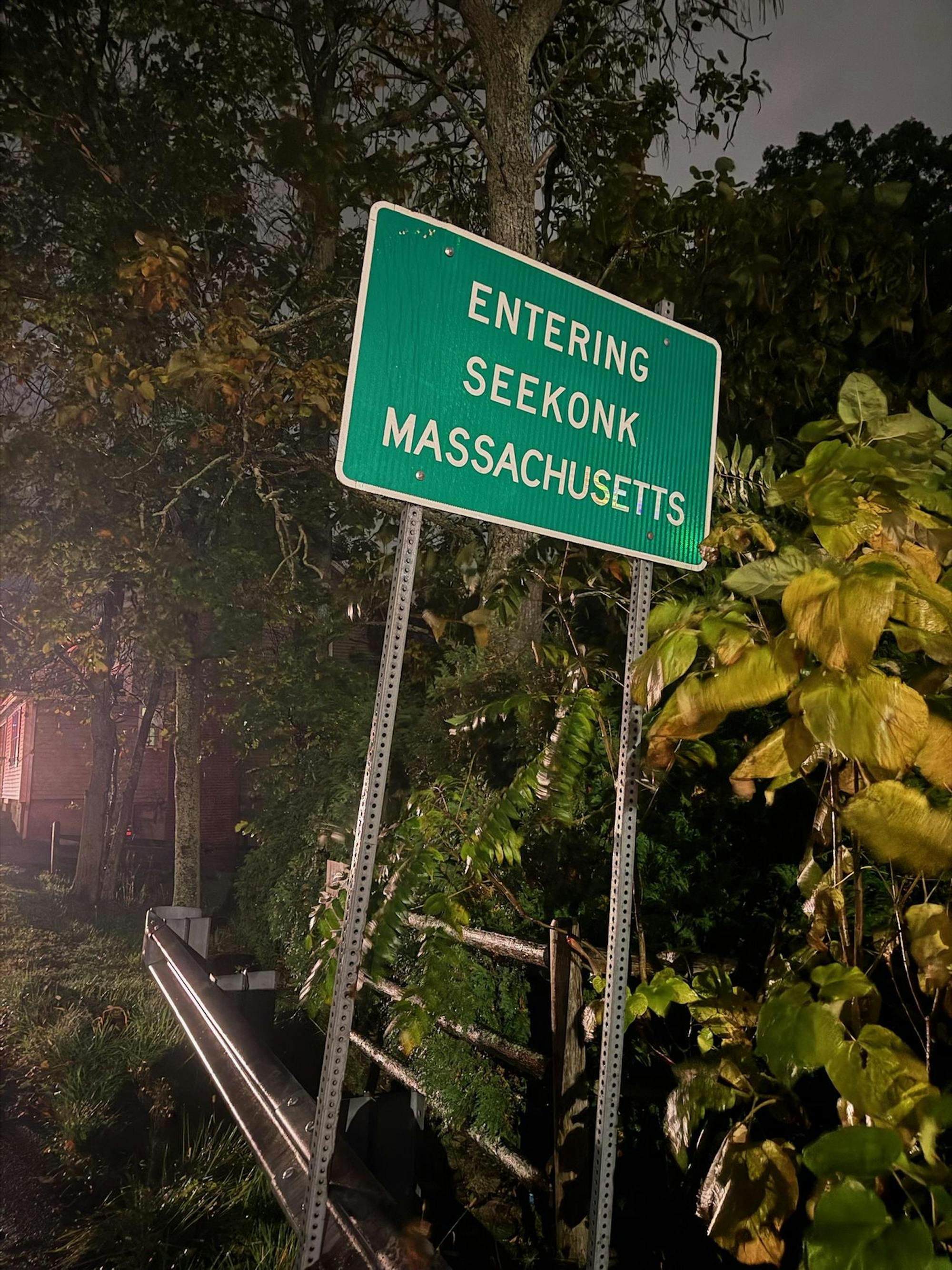 Photo of a green road sign that reads “Entering Seekonk, Massachusetts.”