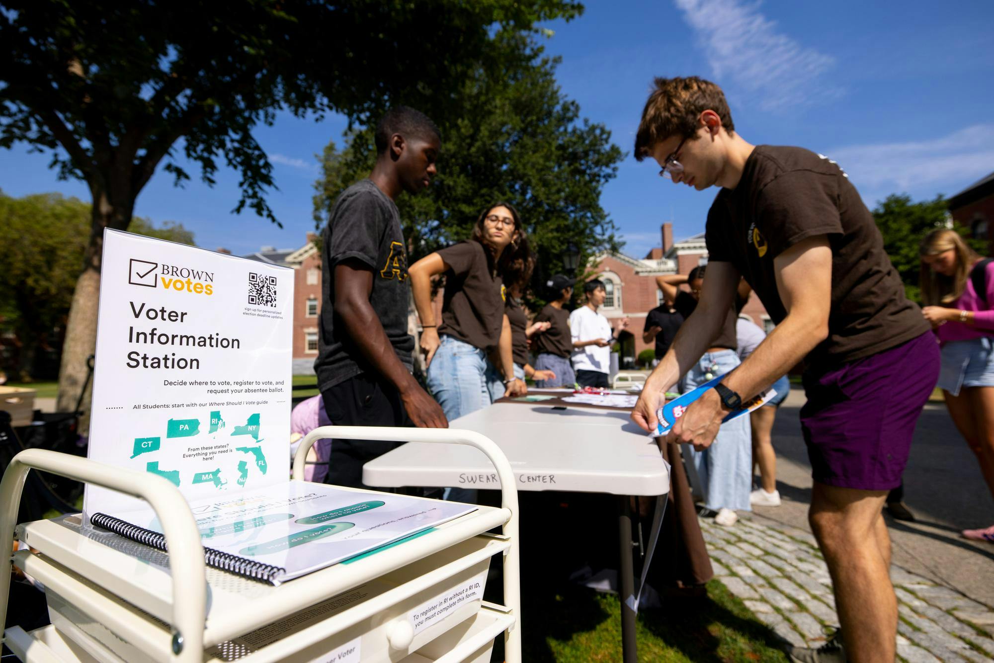 Photo of students from Brown Votes helping people register to vote, request absentee ballots and answer general questions about civic engagement on National Voter Registration Day.