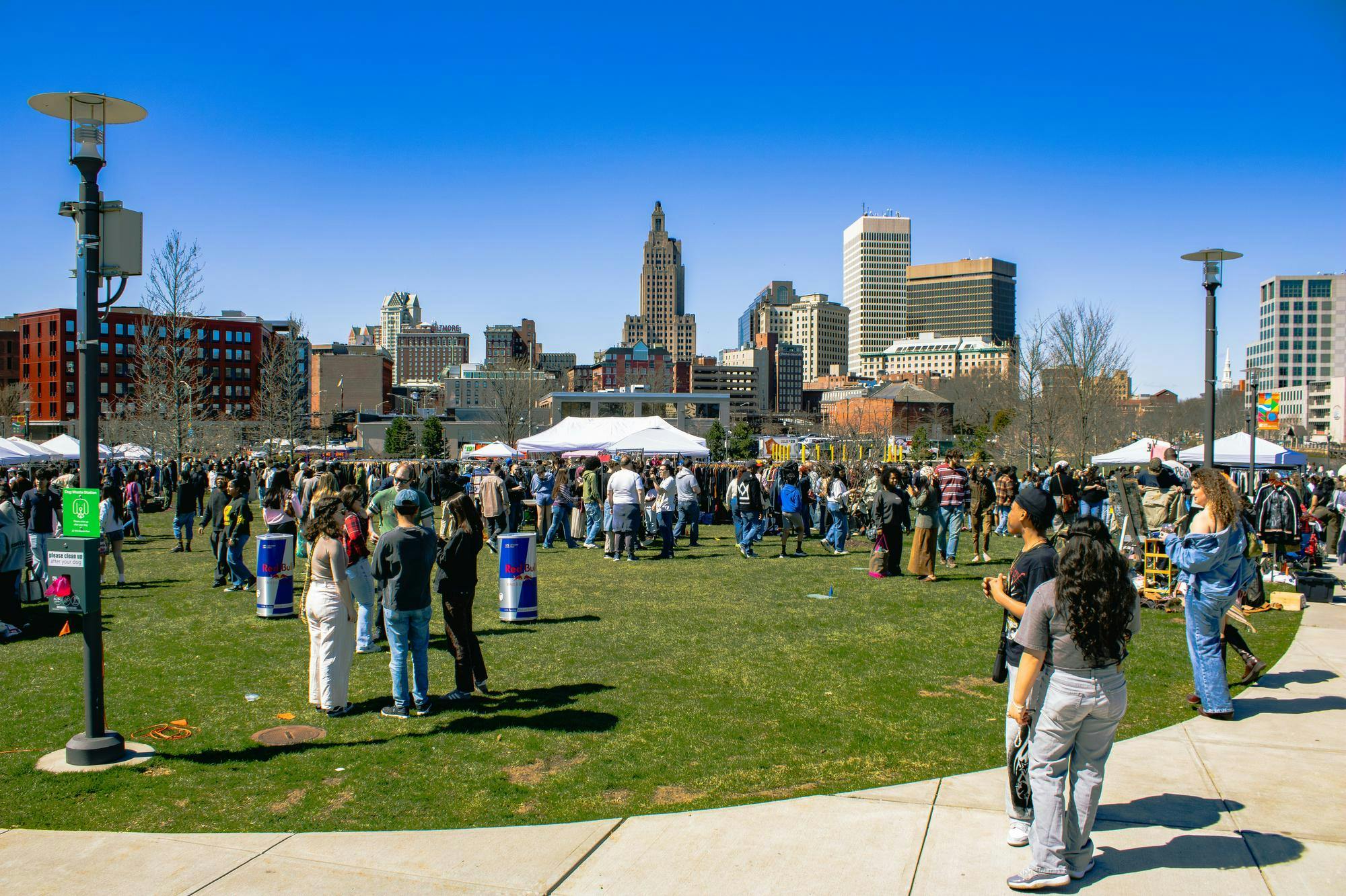 Photo of people at Riverside Park on a sunny day for the thrifting event. 