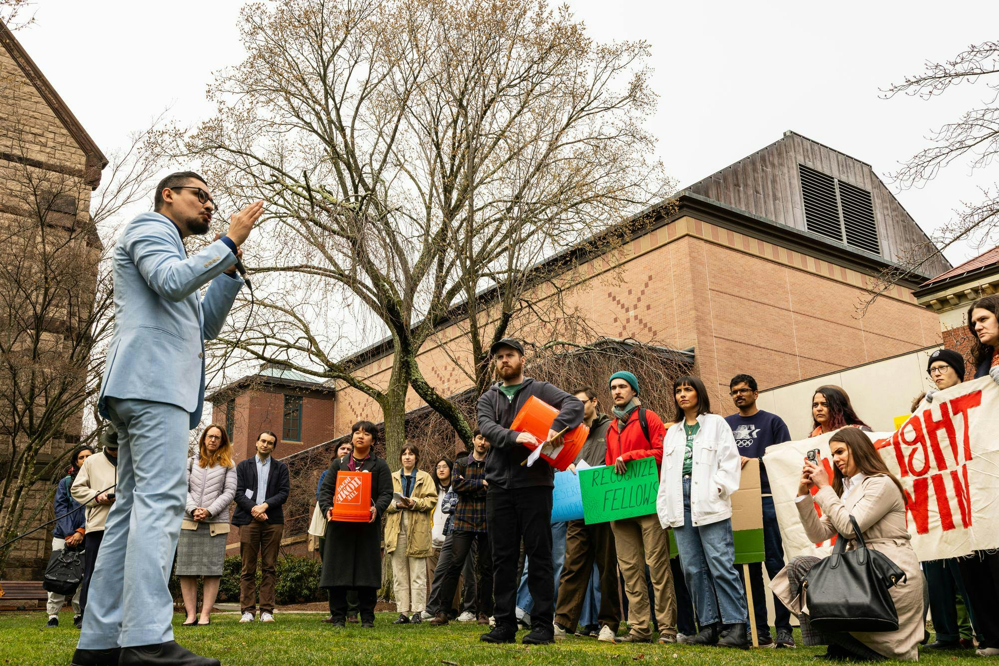 David Morales holds a microphone, addressing the crowd of attendees in front of him.

