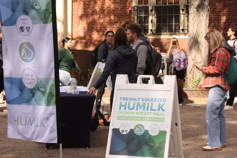 <p>YouTuber and animal rights activist Natalie Fulton talks to students at an event organized by Allied Scholars for Animal protections on Oct 10. The signs and posters for “HuMilk,” or human breast milk, aimed to attract shock and interest so representatives could start conversations with students.</p>