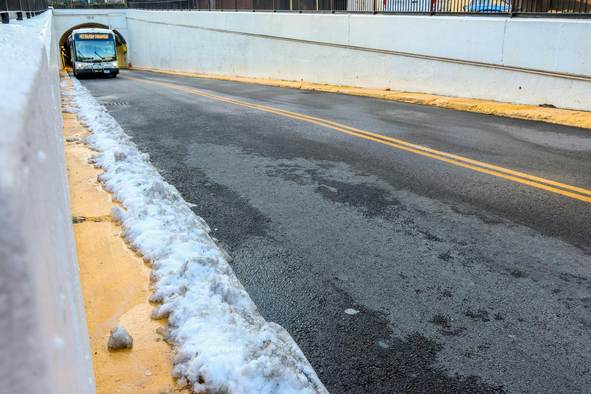 A bus exiting a tunnel.