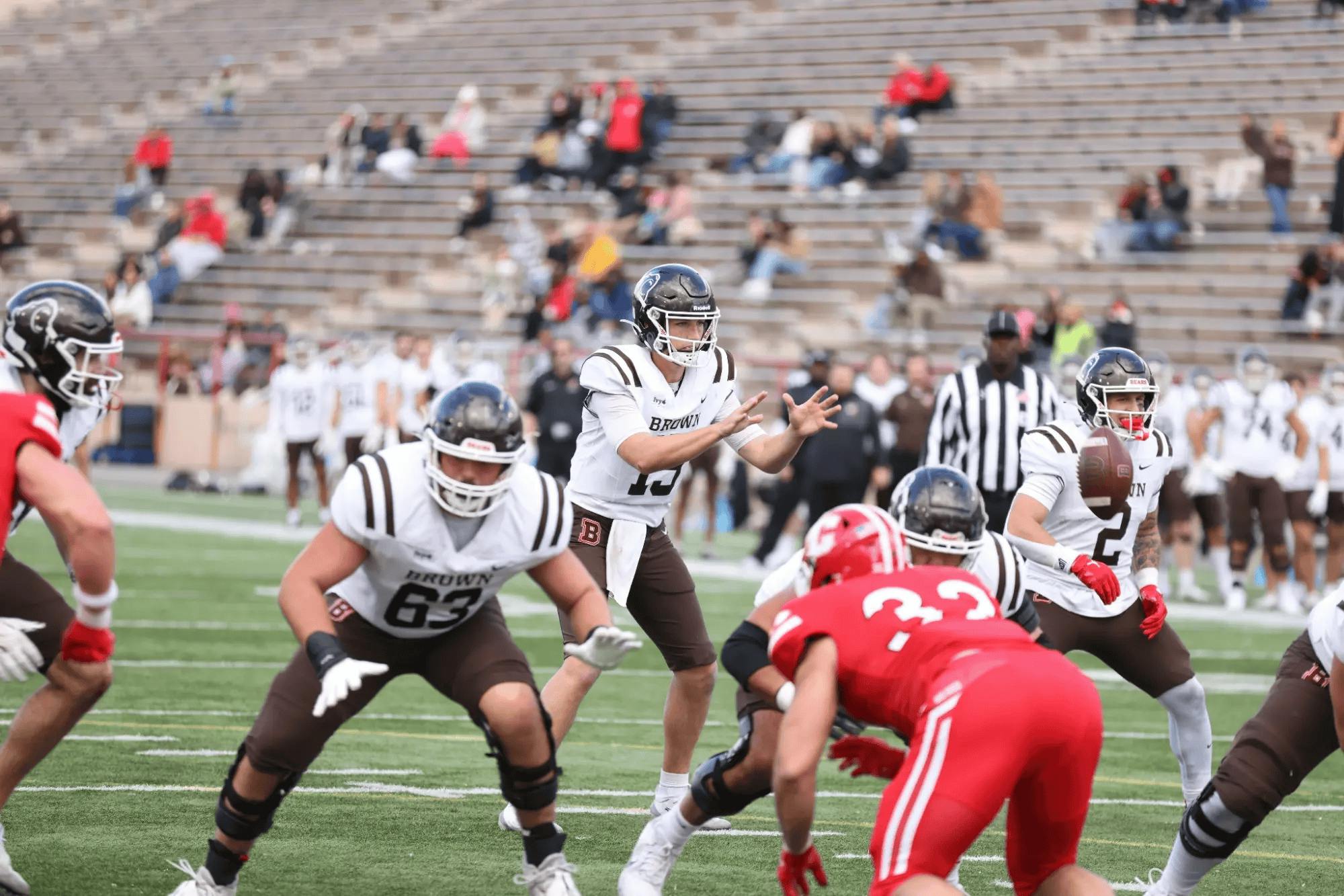 The Brown Bears and Cornell Big Red football players in action on the football field