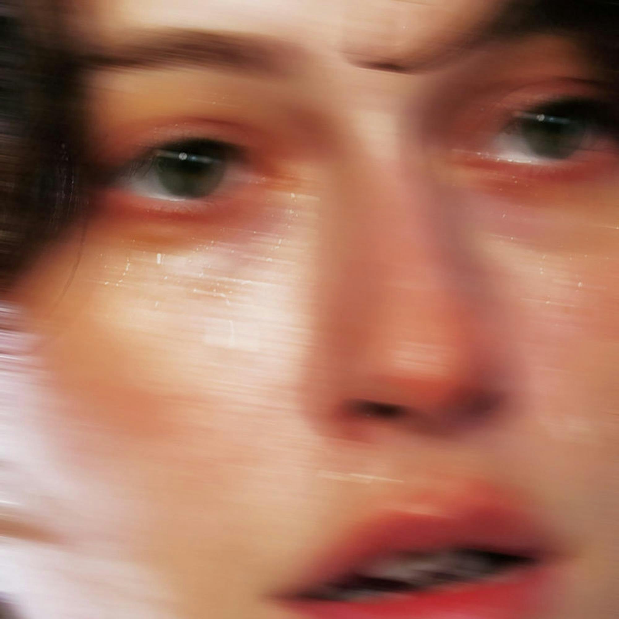 The album cover of musical artist King Princess' latest album, Girl Violence, a close-up photo of a light skinned person with dark hair, the artist herself, looking to the right with slightly damp skin.