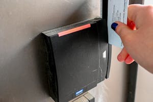 A card swiping to enter door.