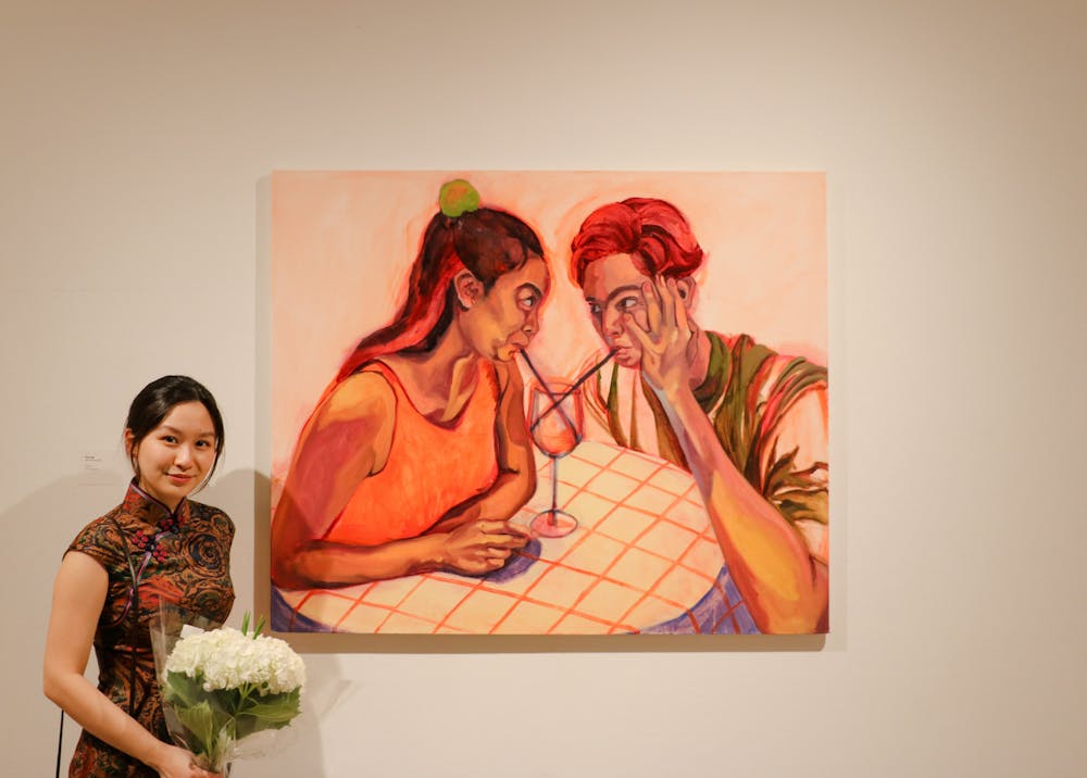 <p>Kitty Ng (above), a senior at RISD, stands next to her painting “S to S.” The event “Painting 1” will be followed by “Painting 2” and a series of senior exhibits showcasing RISD’s range of disciplines. </p><p><br/></p>