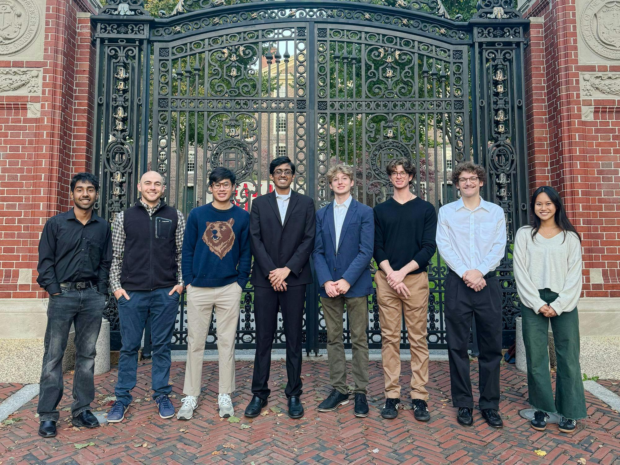 Eight members of Kyron Medical stand in front of the Van Wickle Gates at Brown University.
