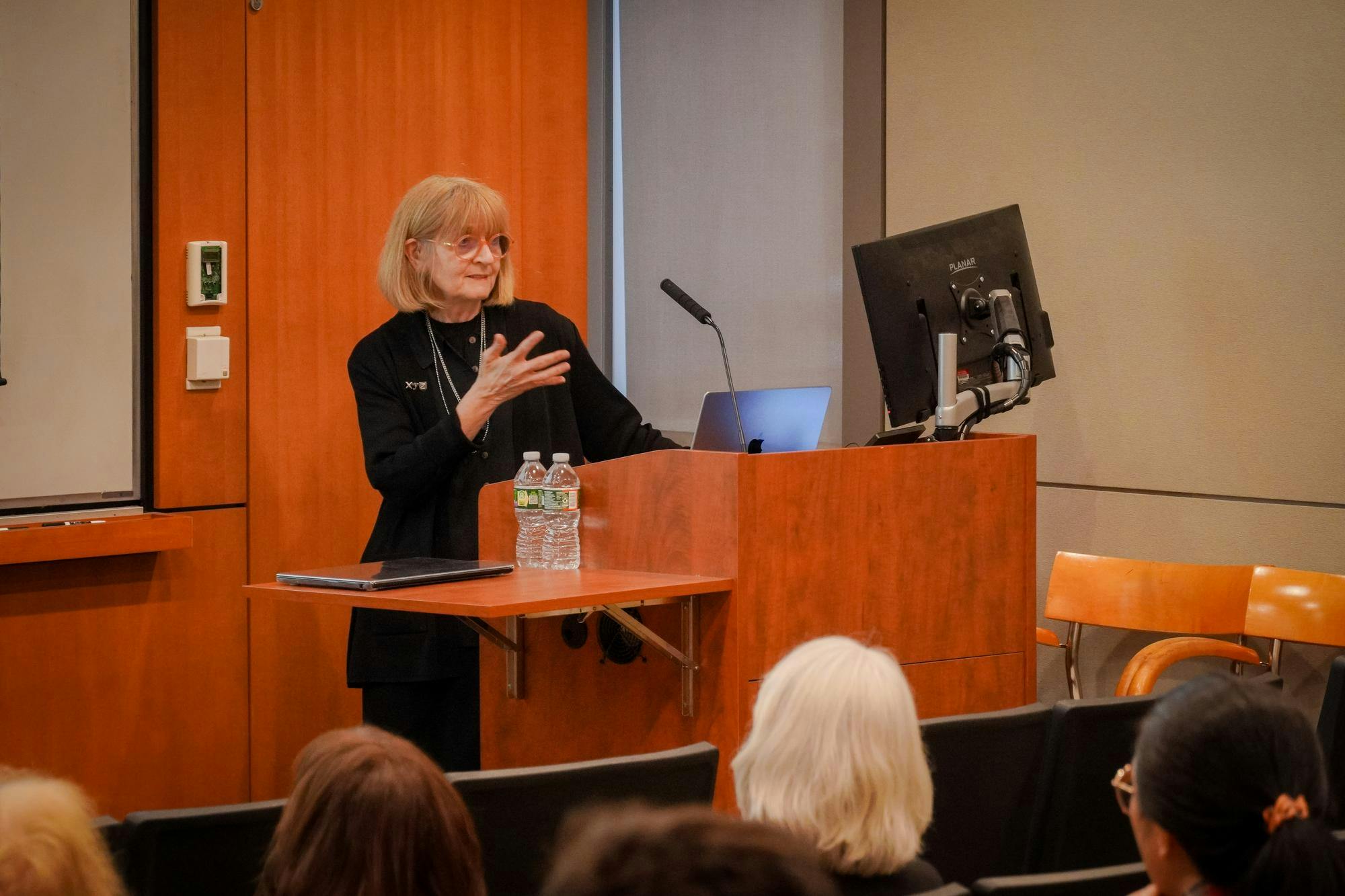 Helen Mayberg speaking in front of a podium