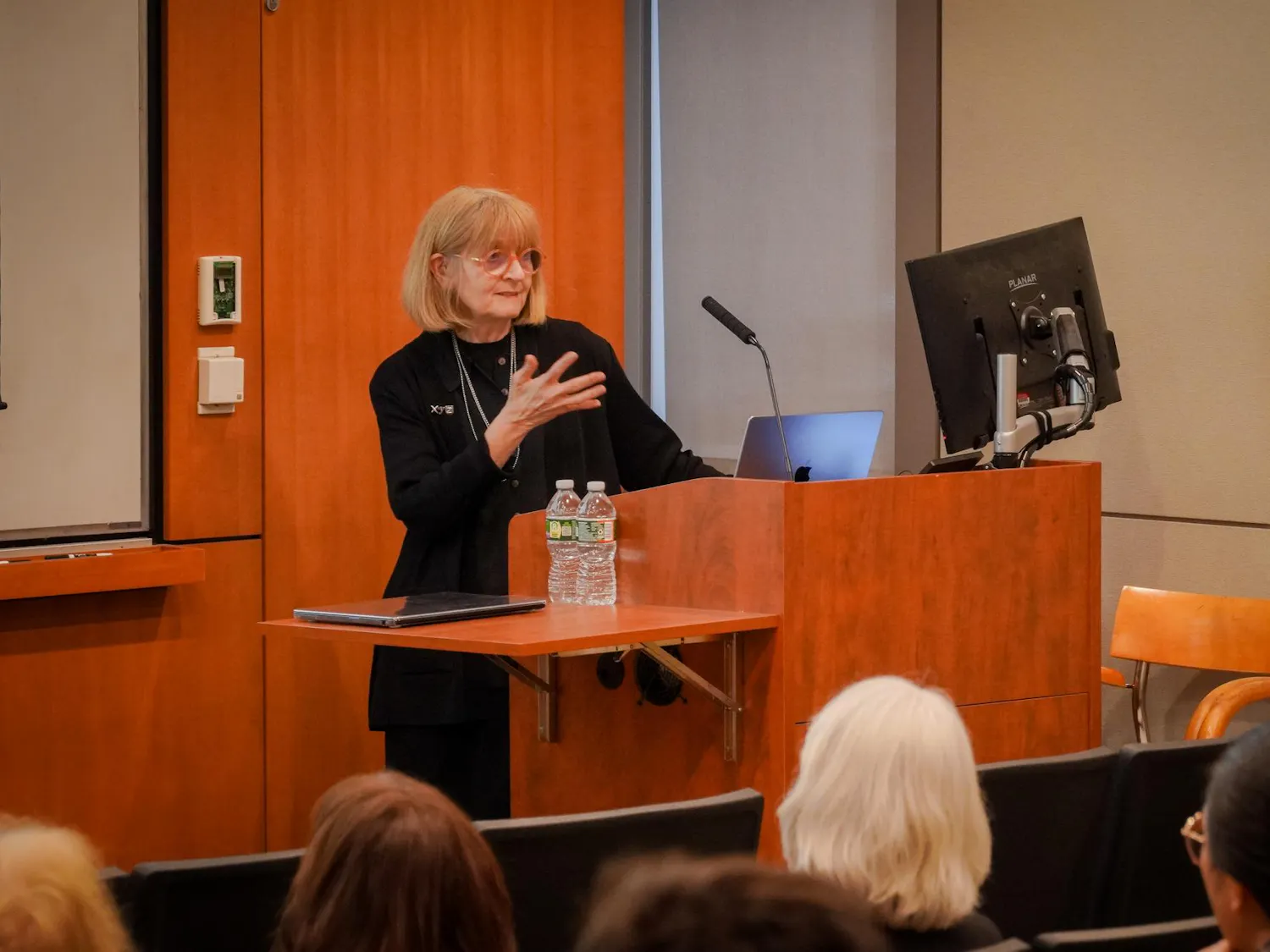 Helen Mayberg speaking in front of a podium