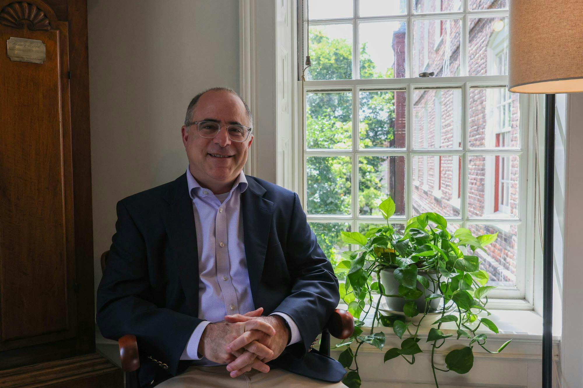 Portrait of a smiling Ethan Pollock, newly appointed dean of the College, in his office.