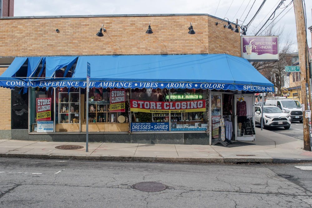 A photo of the exterior of Spectrum India. A building with a blue awning and a sign in the window that reads “STORE CLOSING, EVERYTHING MUST GO.”