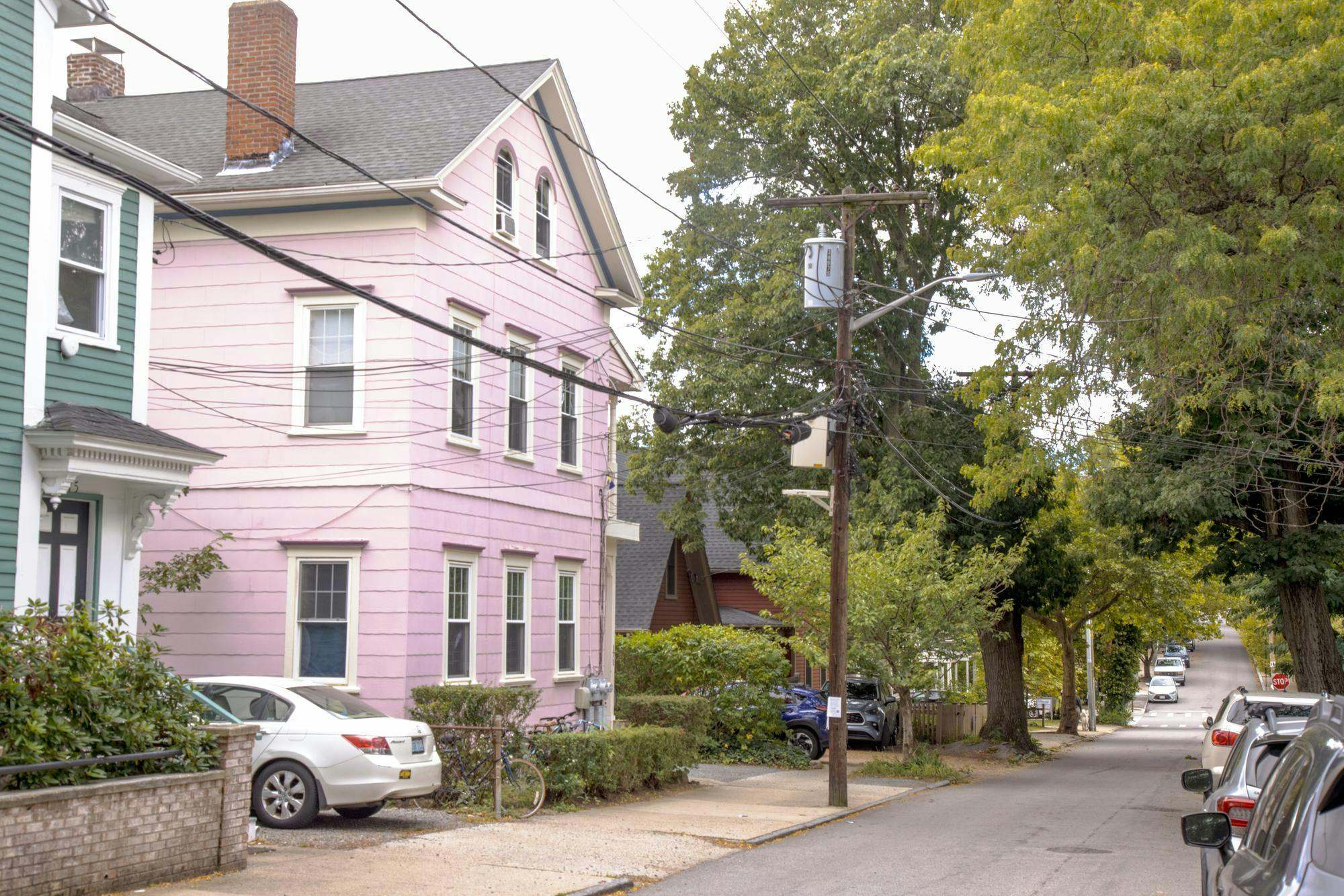 A photo of a pale pink off-campus house on Williams Street on an overcast day.