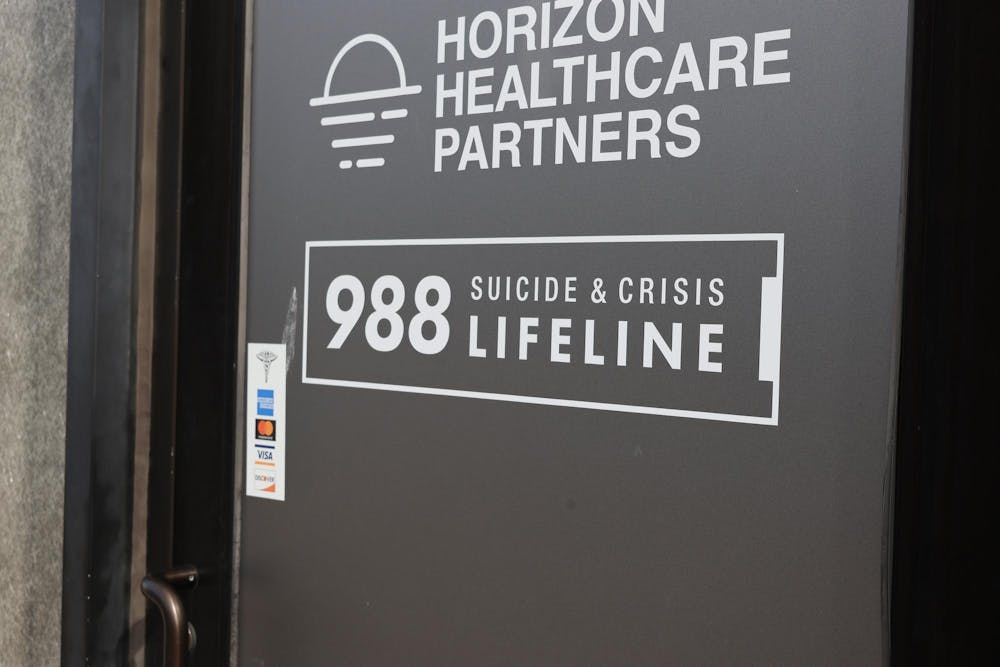 The door of Horizon Healthcare Partners, a behavioral health facility located in East Providence. The door reads "988 Suicide and Crisis Lifeline."