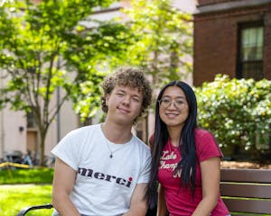 Photo of Semyon Sakhabutdinov with another student on the Main Green.