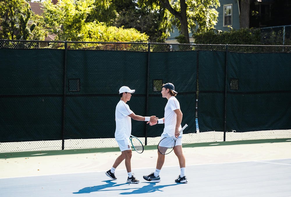 Brian Chong ’25 and George Bader ’25 share a handshake in their doubles match against Quinnipiac.