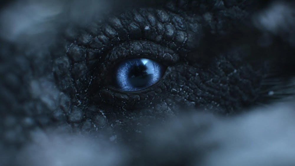 A screen grab from the film “The Dinosaurs” where a blue-eyed dinosaur peaks through a crack.