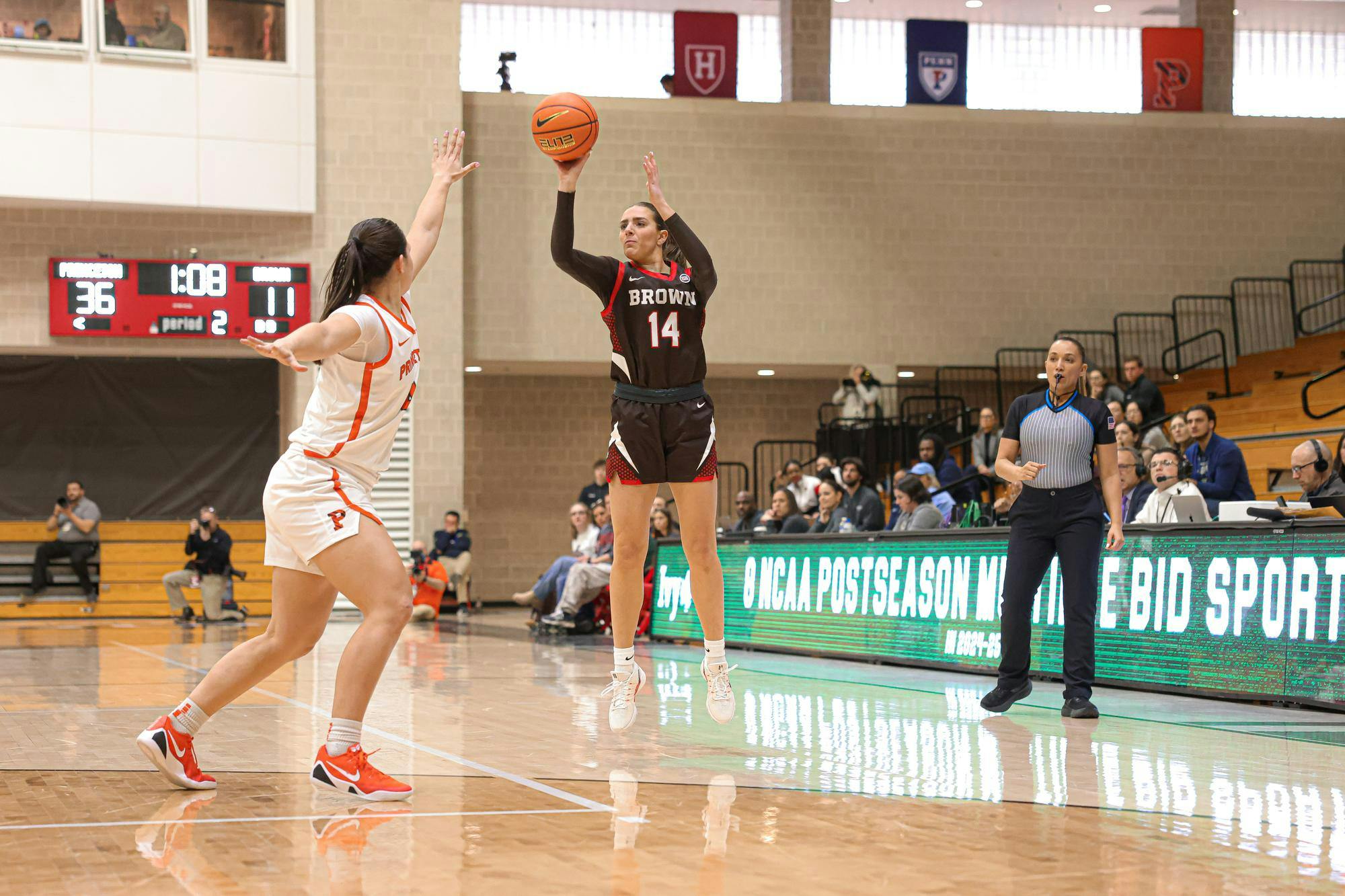 A photo of Mady Calhoun ’26 shooting a three-point shot with a Princeton defender in front of her.