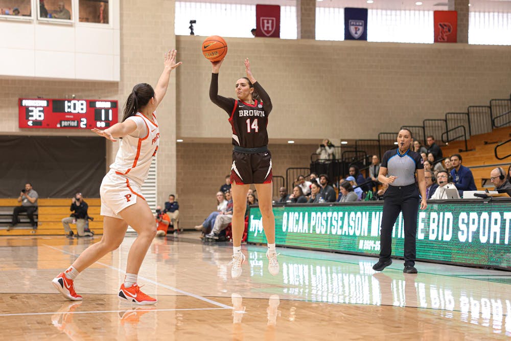 A photo of Mady Calhoun ’26 shooting a three-point shot with a Princeton defender in front of her.