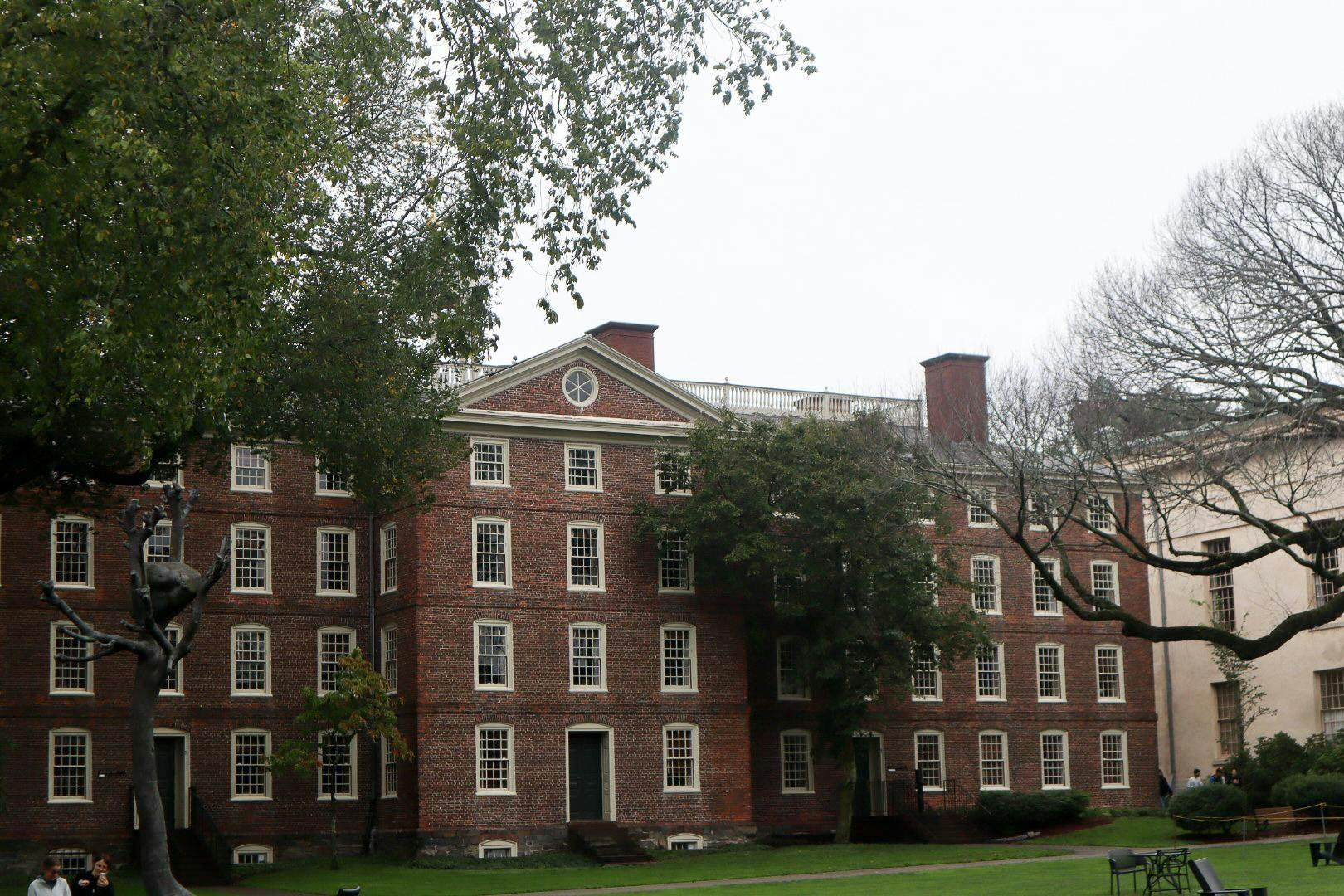 Photo of University Hall with trees in front of it.