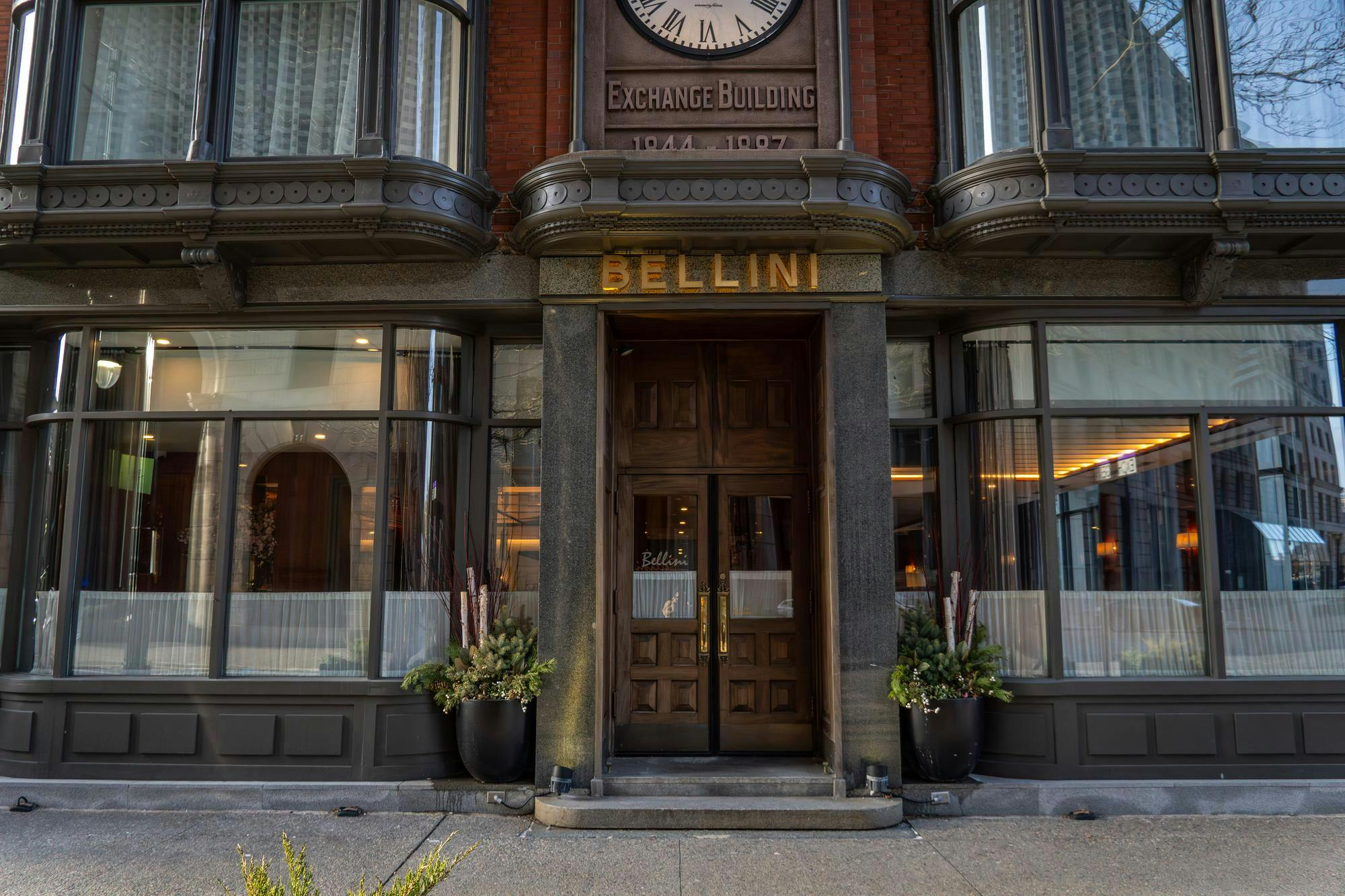 Outside of Bellini's Restaurant, with large wooden doors.