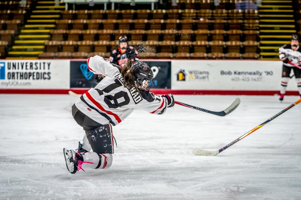 A photo of a hockey player shooting toward a goal, not visible in the picture.  