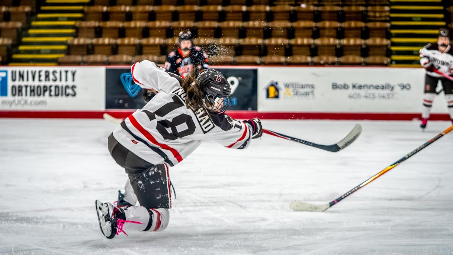 A photo of a hockey player shooting toward a goal, not visible in the picture.