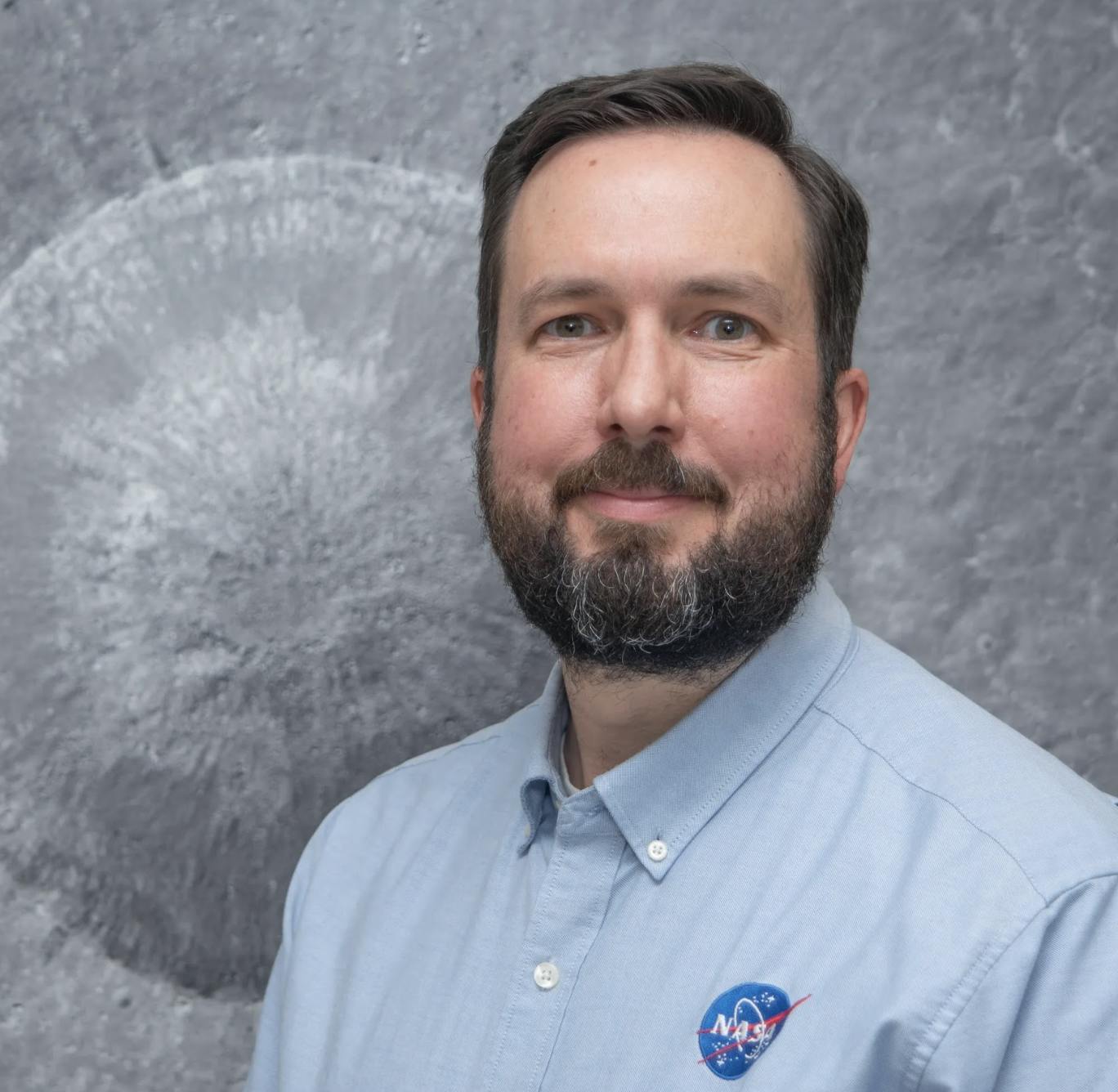 A portrait of Noah Petro in a blue NASA shirt.